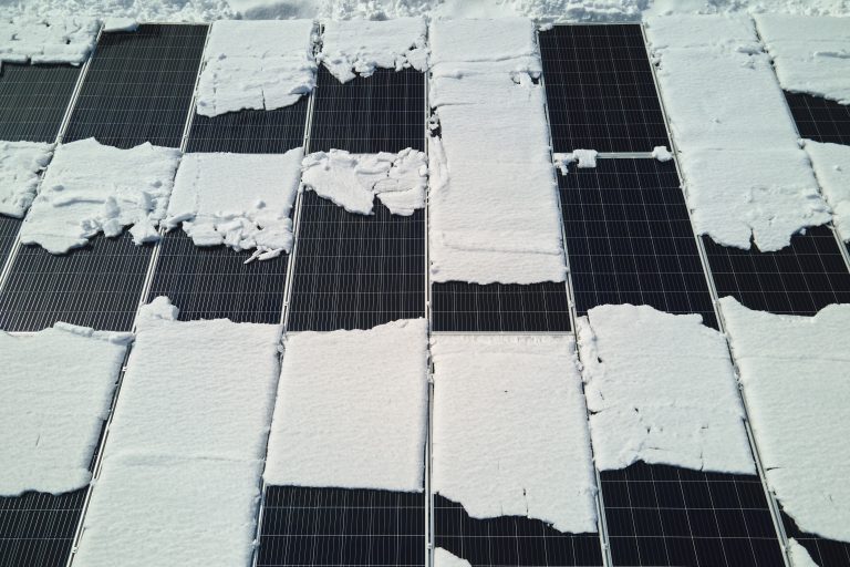 aerial view snow melting from covered solar photovoltaic panels sustainable electric power plant producing clean electrical energy low effectivity renewable electricity winter 768x512 1